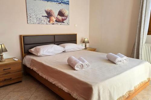 a bedroom with a bed with two pillows on it at Calliestia 7 in Chios