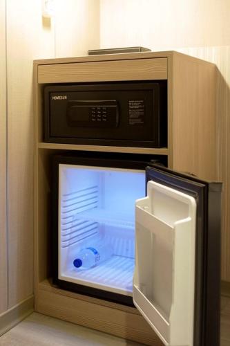 a microwave with its door open inside of it at Poshpacker Hotel in Taipei