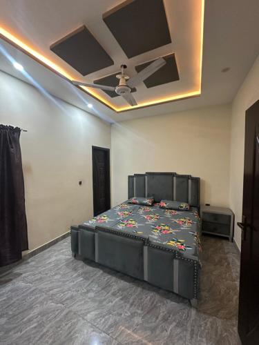 a bedroom with a bed and a ceiling at Furnished Home in Jhelum in Jhelum