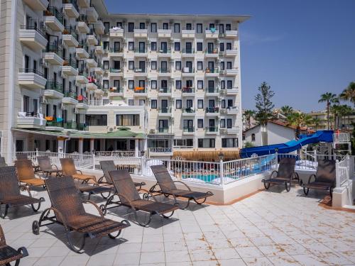 a group of chairs sitting in front of a hotel at Sun Fire Beach Hotel - All Inclusive in Alanya
