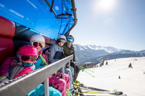 a group of people sitting on a ski lift at Penthouse Sonnenplatzl in Radfeld