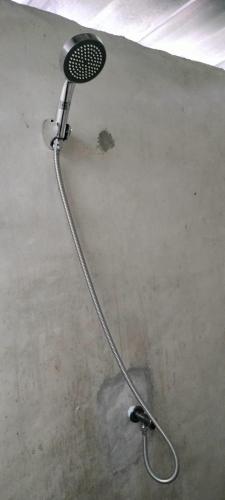 a shower in a room with a shower head at Mountain Jungalows, Koh Chang in Trat