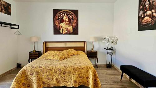 a bedroom with a bed with a yellow blanket on it at villa luxueuse en Provence, Luberon in Mane