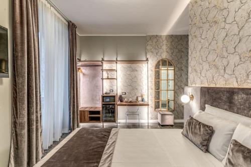 a bedroom with a large bed and a window at Apollo Boutique Hotel in Rome