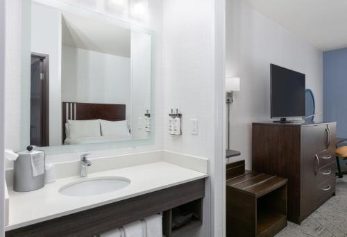 a bathroom with a sink and a large mirror at Holiday Inn Express Spokane-Valley by IHG in Spokane Valley
