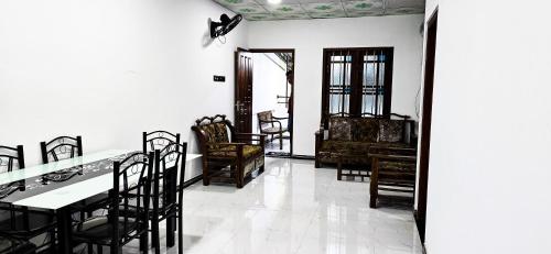 a dining room with a table and chairs at Zainy Holiday Apartment in Galle