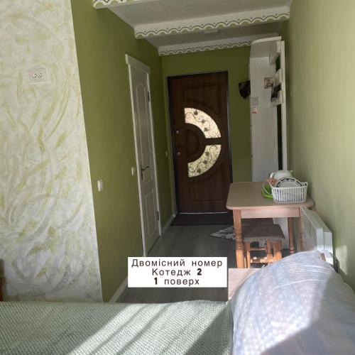 a bedroom with a door and a sign in front of it at Pidkova in Verkhovyna