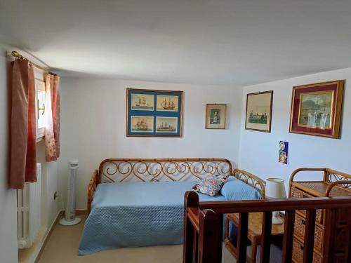 a bedroom with a bed with a blue comforter at Casa Scilla in Trani
