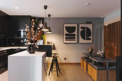 a kitchen with black and white walls and a white counter at Timbre Boavista in Porto