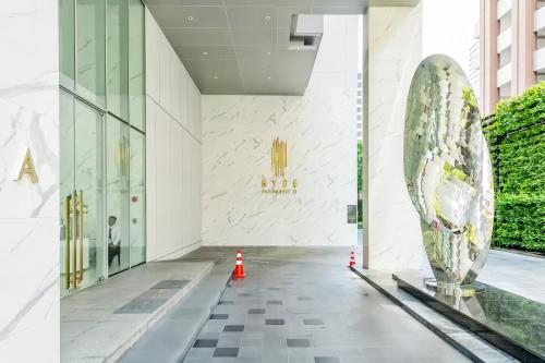 a lobby of a building with a sculpture in the middle at Hyde Sukhumvit 11 Bangkok in Bangkok