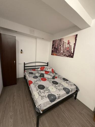 a bedroom with a bed with a quilt on it at Casa Bucovineană in Iaşi