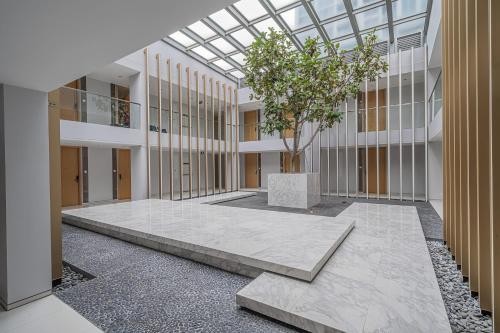 arium of a building with a tree in the middle at Hyde Sukhumvit 11 Bangkok in Bangkok
