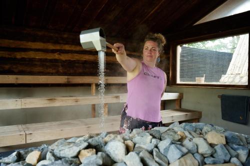 a woman standing in a room with a water fountain at Danhostel Nørresundby Skansen in Nørresundby