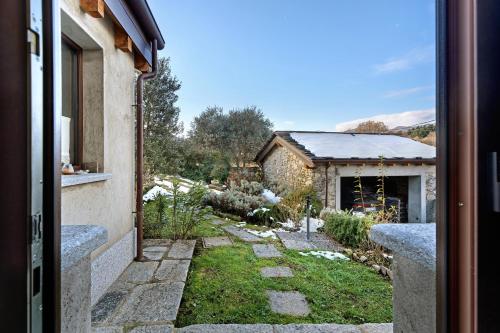 a view of a garden from the door of a house at Charmingly Renovated Stone House in Cesara