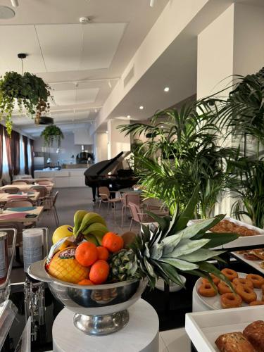 a bowl of fruit on a table in a restaurant at Best Western Hotel Massafra in Massafra