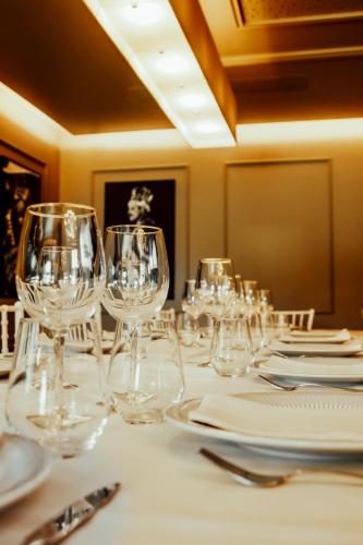 a table with empty wine glasses on it at Quinta das Areias - Solar da Pena in Braga