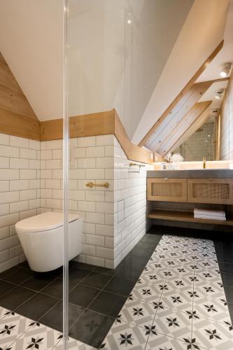 a bathroom with a shower and a tub and a toilet at Villa La Roca Garden and Spa in Kościelisko