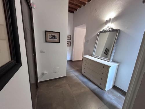 einen Flur mit einer Kommode mit einem Spiegel darauf in der Unterkunft Magda house in Montelupo Fiorentino