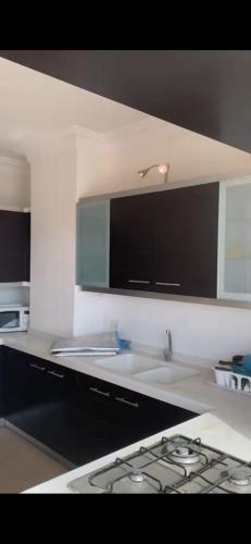 a kitchen with a sink and a counter top at Omar in Al Bunayyāt ash Shamālīyah