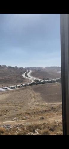 a view of a road in the desert from an airplane at Omar in Al Bunayyāt ash Shamālīyah