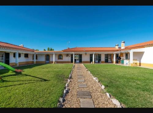 a person throwing a frisbee in front of a building at Spacious villa with private pool in Grândola in Grândola