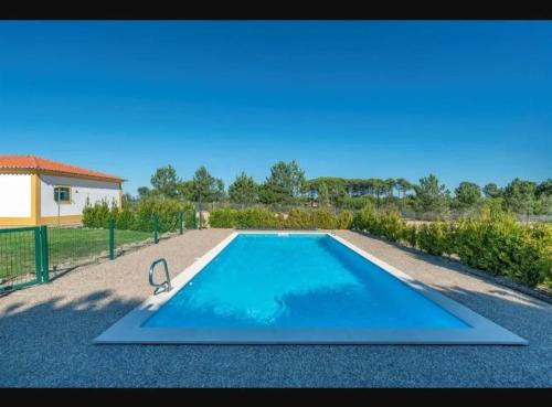 a swimming pool in the middle of a yard at Spacious villa with private pool in Grândola in Grândola