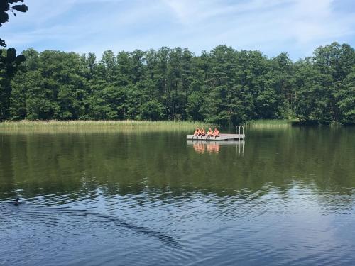 a group of people in a boat on a lake at Blockhausvermietung Himmelpfort in Pian
