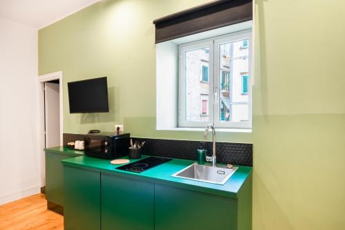 a kitchen with a sink and a window at The Idyll Boutique apartment - Suite in Napoli's Spanish Quarters in Naples