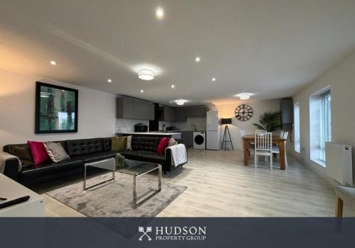 a living room with a couch and a table at Shrewsbury Townhouse with 3 En-suites in Shrewsbury