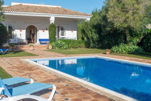 a swimming pool in front of a house at Villa Iris in Benalup Casas Viejas