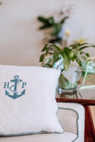 a pillow with an anchor on it sitting on a table at Hotel Parrini in Follonica