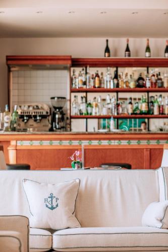 a living room with a couch in front of a counter at Hotel Parrini in Follonica