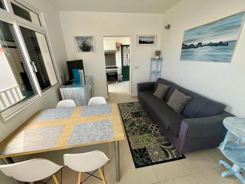 a living room with a couch and a table at Villa SCIROCCO Madeira - Ocean View in Machico