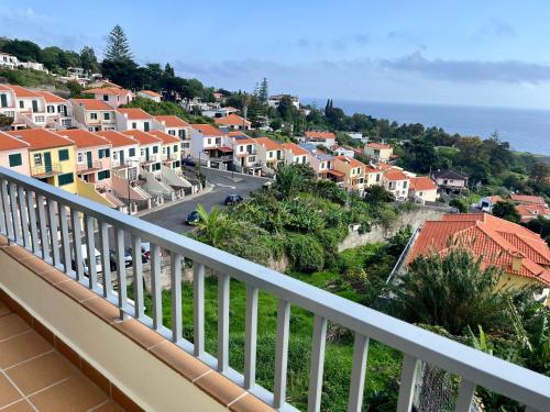 a view of a town from a balcony at Villa SCIROCCO Madeira - Ocean View in Machico