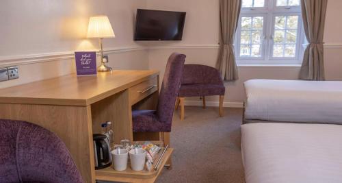 a hotel room with a desk and a bed at Worcester Bank House Hotel Spa & Golf; BW Premier Collection in Worcester