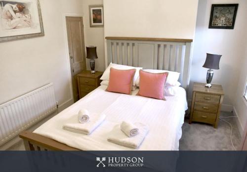 a bedroom with a bed with two towels on it at Town Centre Period Property by Shrewsbury Abbey in Shrewsbury