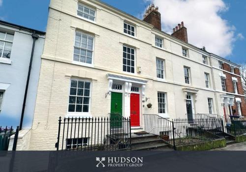 a large white building with a red and green door at Town Centre Period Property by Shrewsbury Abbey in Shrewsbury