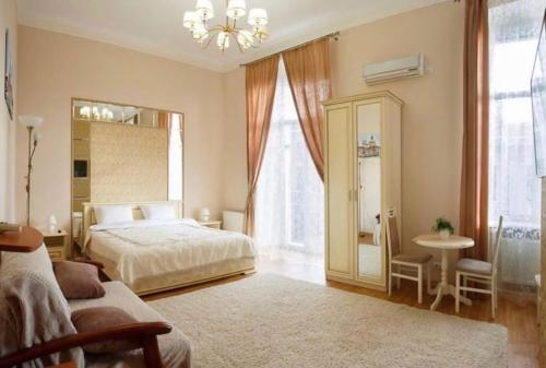 a bedroom with a bed and a table and a window at Apartment on Sumskaya 46 "Central Residence" in Kharkiv