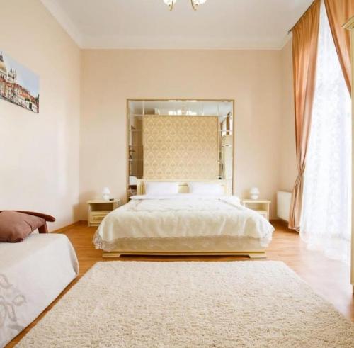 a bedroom with a large bed and a large mirror at Apartment on Sumskaya 46 "Central Residence" in Kharkiv