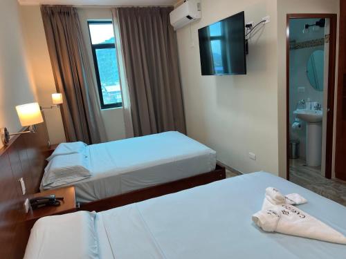 Un ou plusieurs lits dans un hébergement de l'établissement Caruzo Hotel and suites