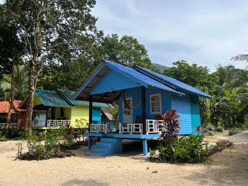 a small blue and yellow house with a porch at Baanbua bungalows Koh Chang Ranong in Koh Chang Ranong