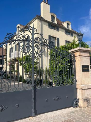 a black gate in front of a building at Number 8 in Meursault