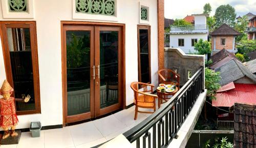 a balcony with sliding glass doors on a building at Arya homestay in Ubud