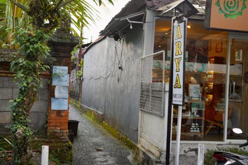 a shop with a sign on the side of a building at Arya homestay in Ubud