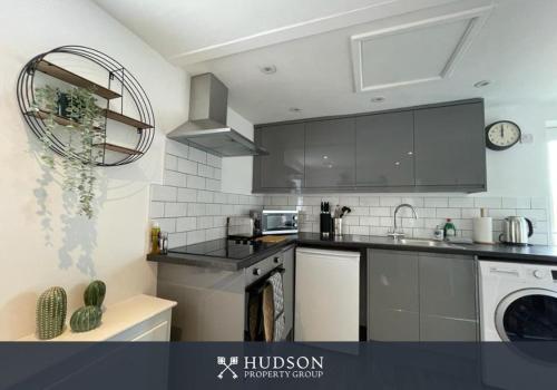 a kitchen with a sink and a dishwasher at Contemporary 1 Bedroom Apartment in Wellington