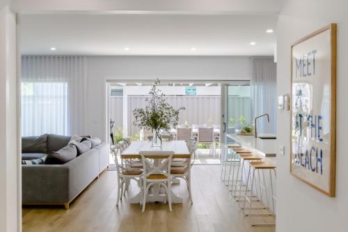 a kitchen and living room with a table and chairs at Coastal Dreams (#1) in Dromana
