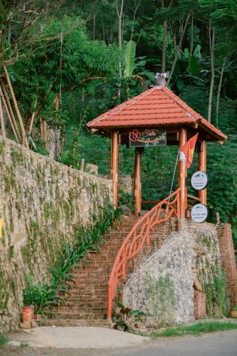 a small building on a brick staircase with a gate at Pù Luông Sala Homestay in Hương Bá Thước