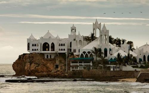 a large white building on the beach near the water at Holiday Inn Express & Suites Mazatlan by IHG in Mazatlán