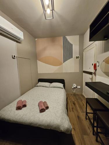 a bedroom with a bed with two slippers on it at Zen Apartments Belzoni in Padova