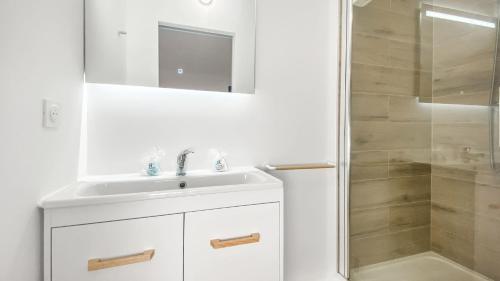 a white bathroom with a sink and a shower at HOMEY LA COLOC BRILLANT - Colocation haut de gamme de 3 chambres uniques et privées / Proche centre-ville et transports en commun / Balcons / Wifi gratuit in Annemasse